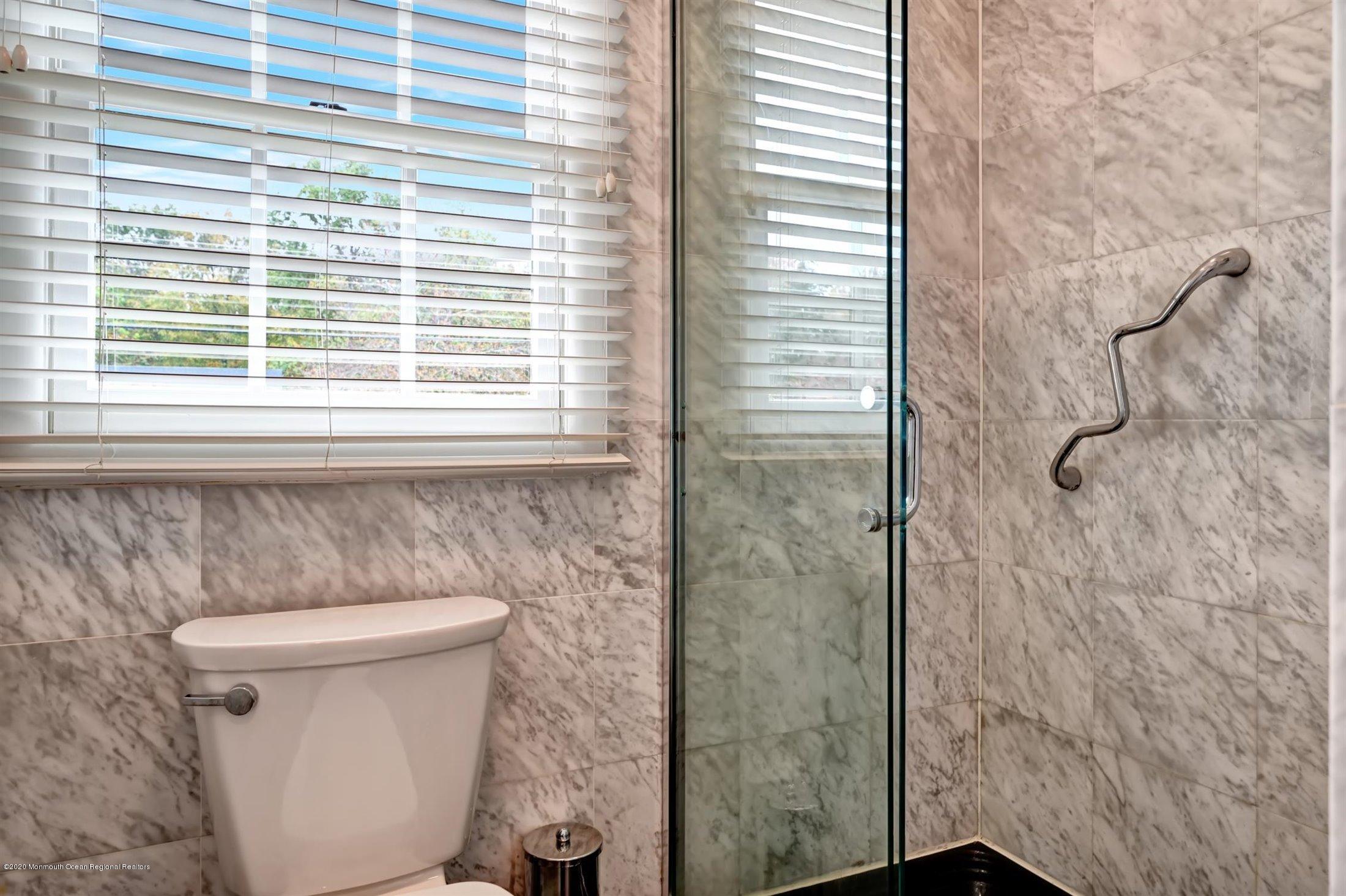 4 Canadian Woods Road Marlboro, NJ 07746 - Photo 17 of 33 a bathroom with a toilet and a shower