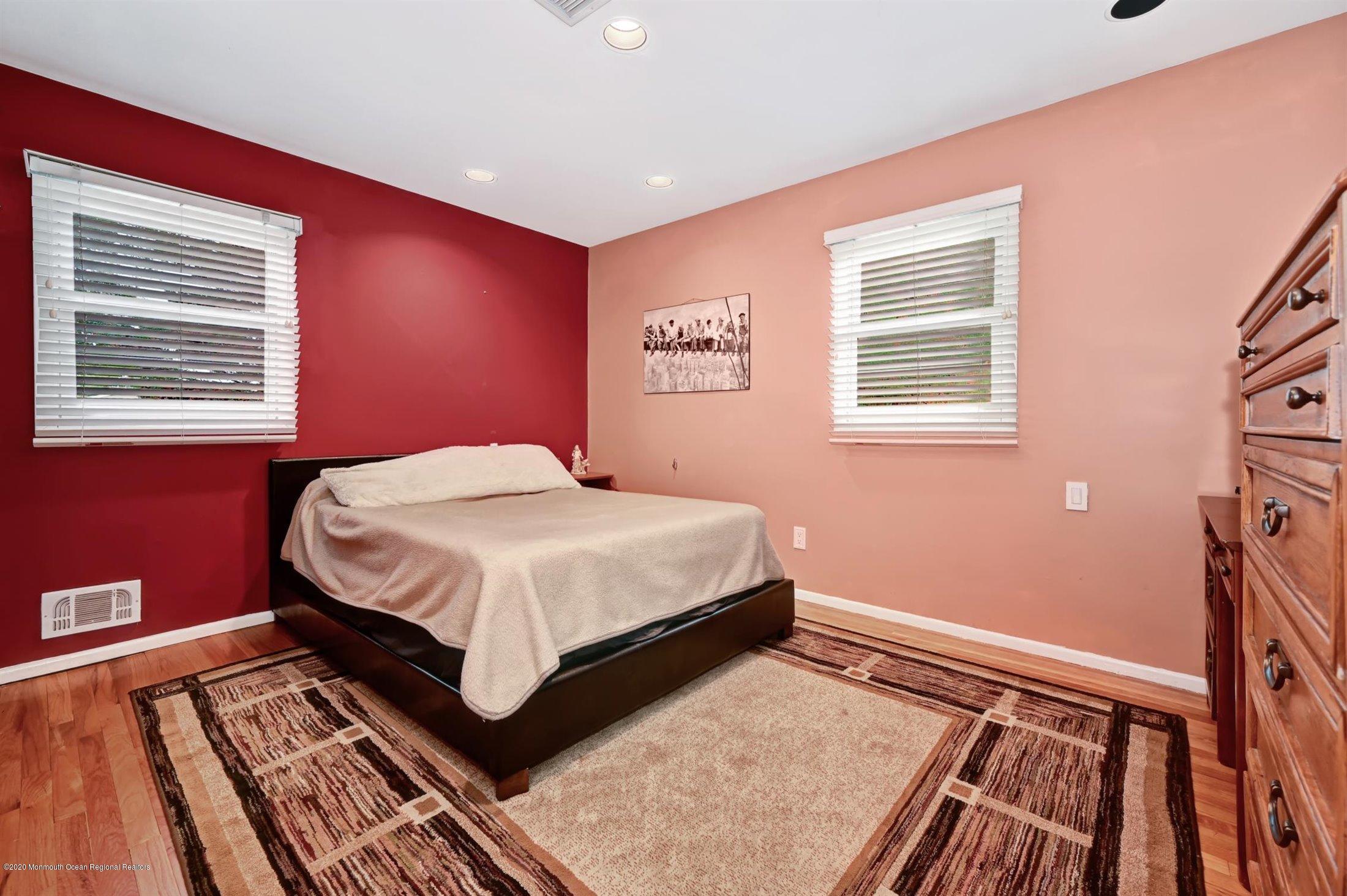 4 Canadian Woods Road Marlboro, NJ 07746 - Photo 21 of 33 a bedroom with a bed and wooden floor