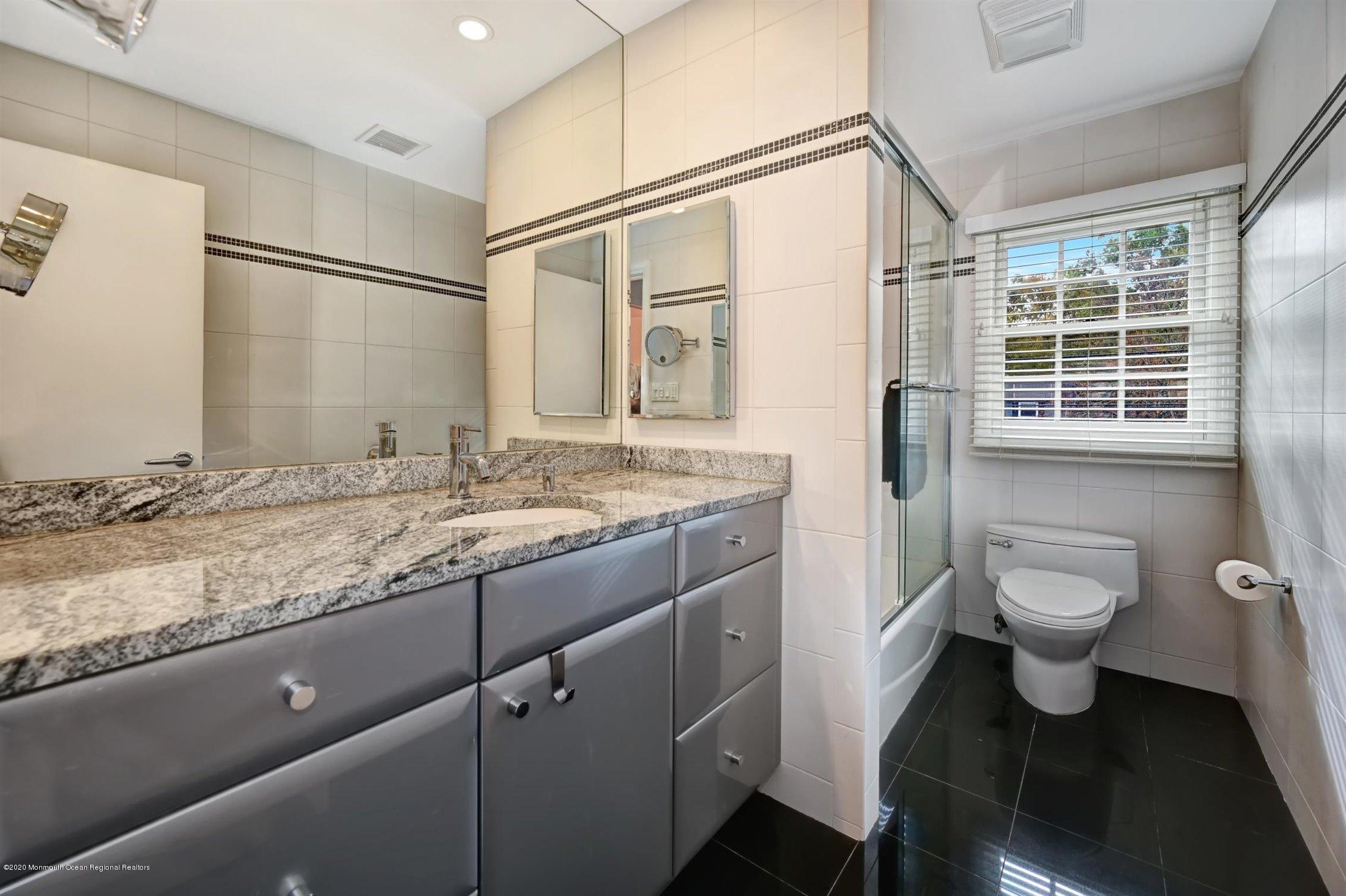 4 Canadian Woods Road Marlboro, NJ 07746 - Photo 22 of 33 a bathroom with a granite countertop sink toilet and shower