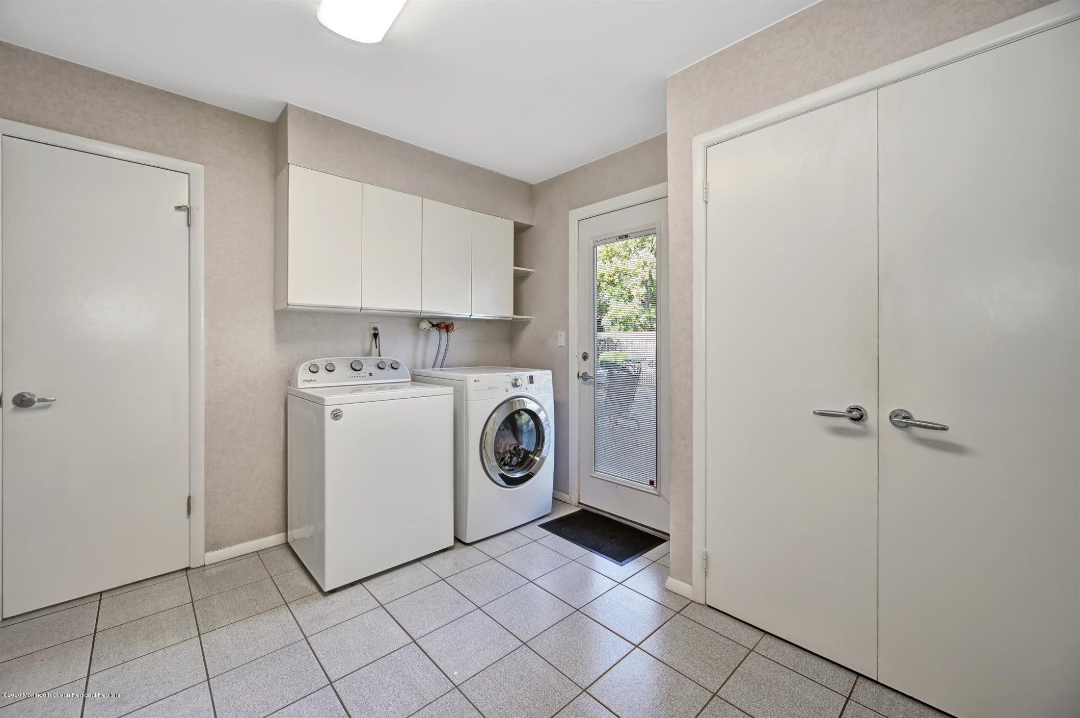 4 Canadian Woods Road Marlboro, NJ 07746 - Photo 23 of 33 a utility room with cabinets washer and dryer