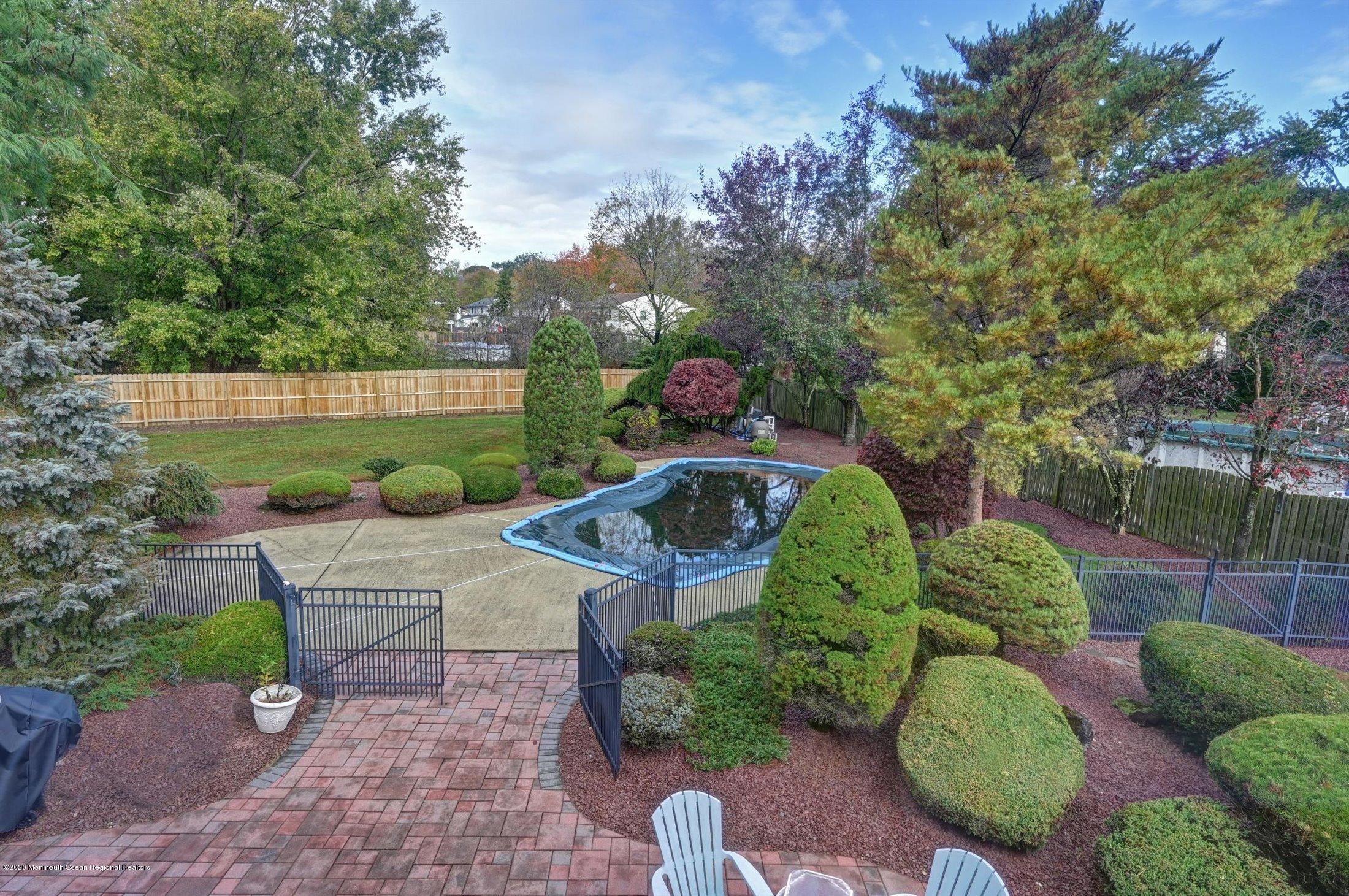4 Canadian Woods Road Marlboro, NJ 07746 - Photo 24 of 33 a view of a backyard with plants and a patio