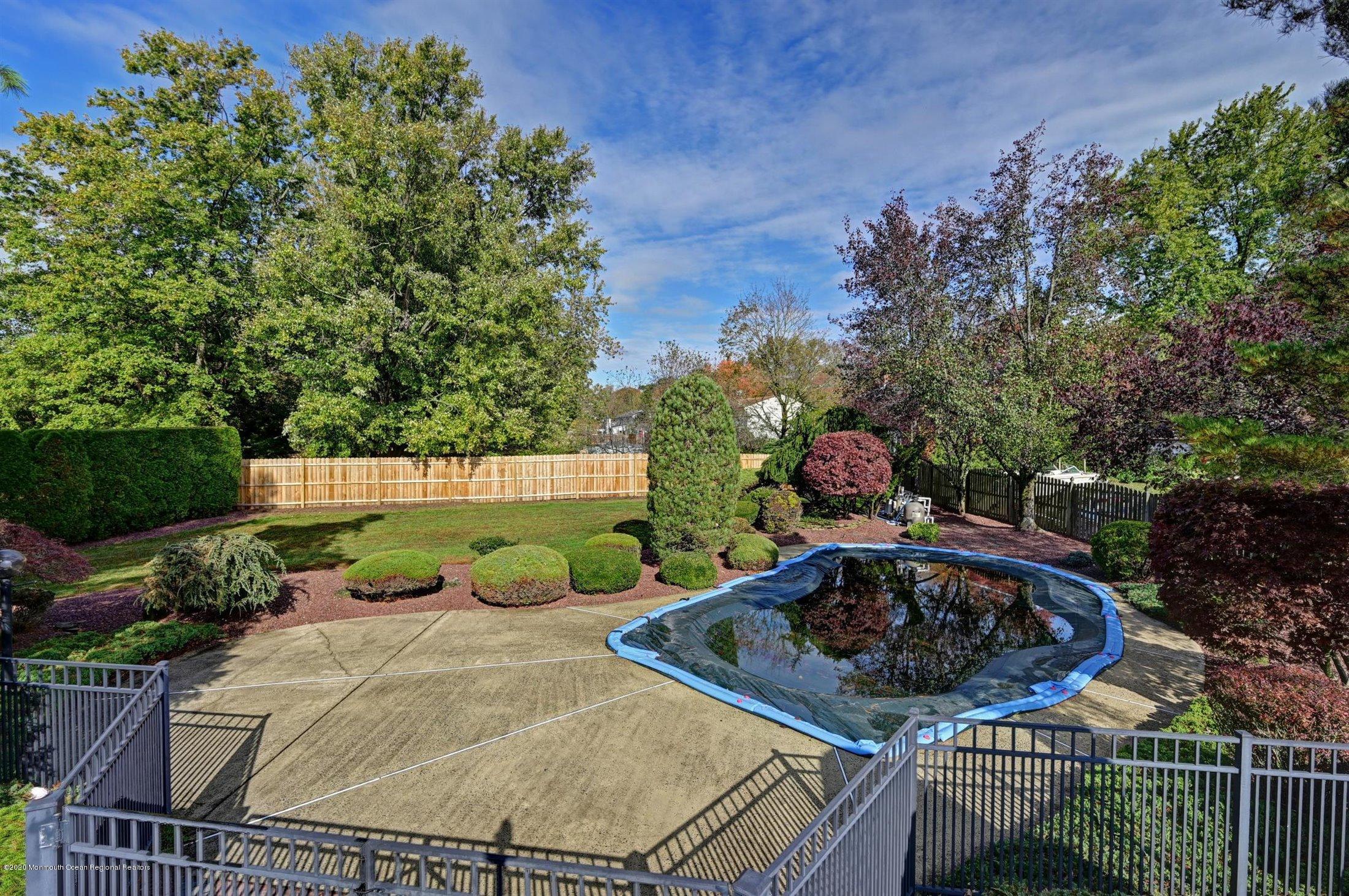 4 Canadian Woods Road Marlboro, NJ 07746 - Photo 25 of 33 a view of a backyard with plants and outdoor seating