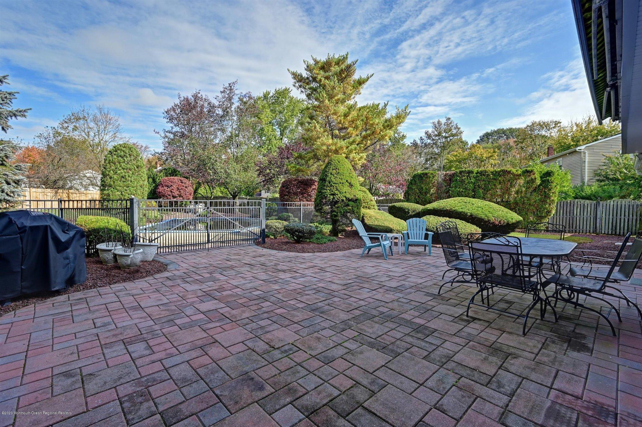 4 Canadian Woods Road Marlboro, NJ 07746 - Photo 27 of 33 a view of a backyard with sitting area