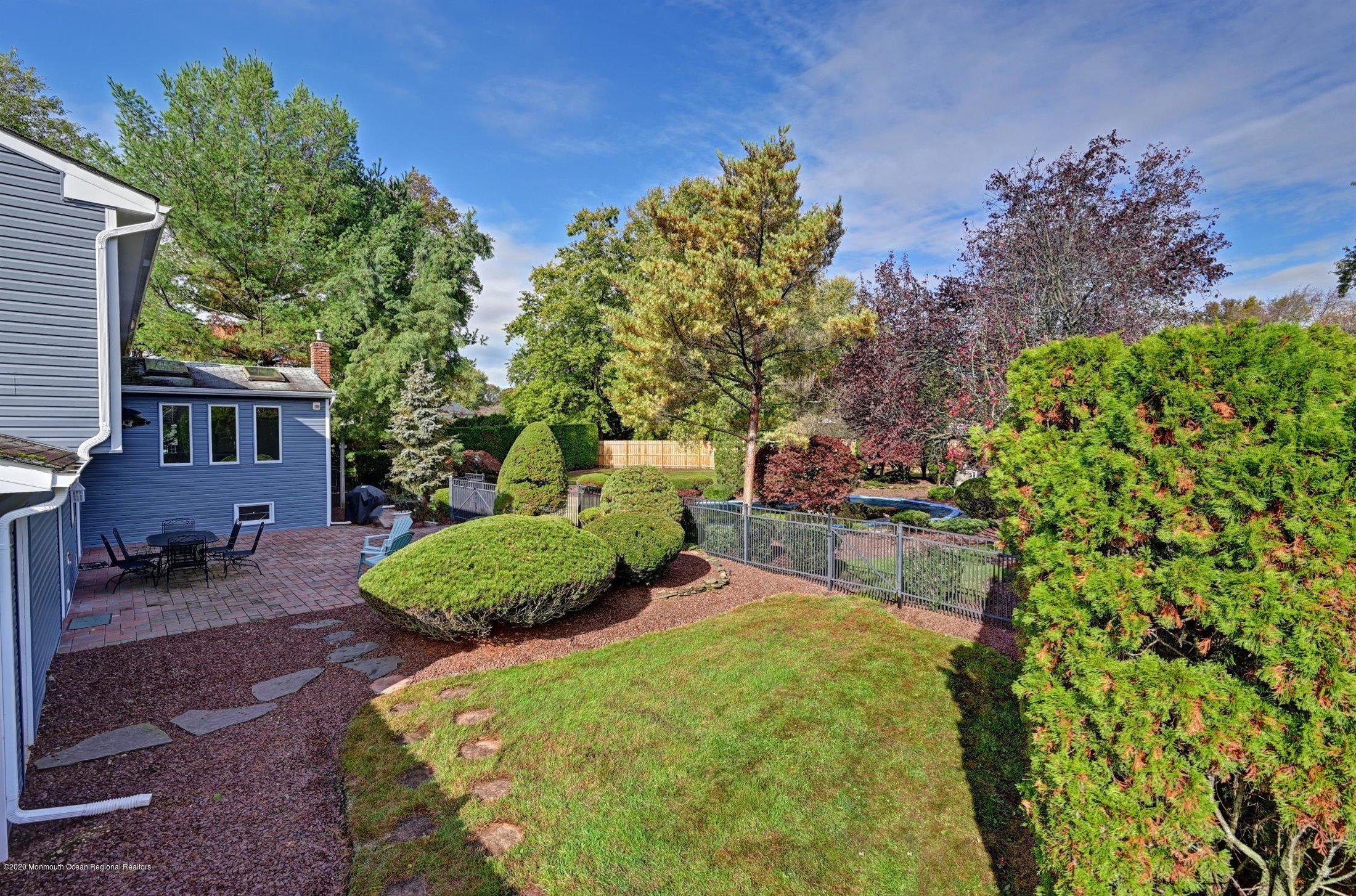 4 Canadian Woods Road Marlboro, NJ 07746 - Photo 29 of 33 a view of a backyard with plants and a patio