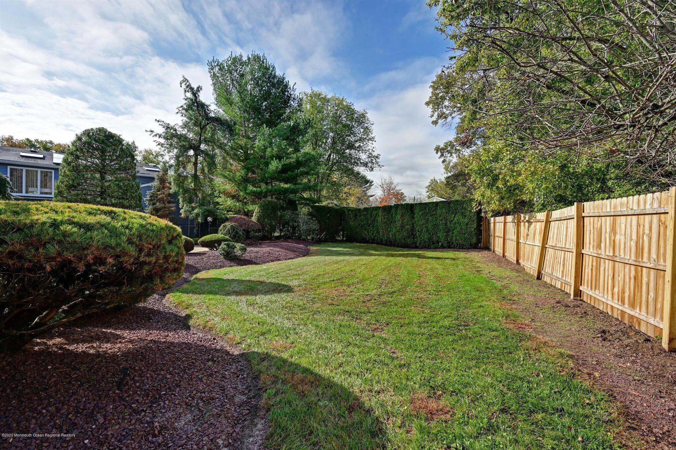 4 Canadian Woods Road Marlboro, NJ 07746 - Photo 30 of 33 a view of a backyard with green space