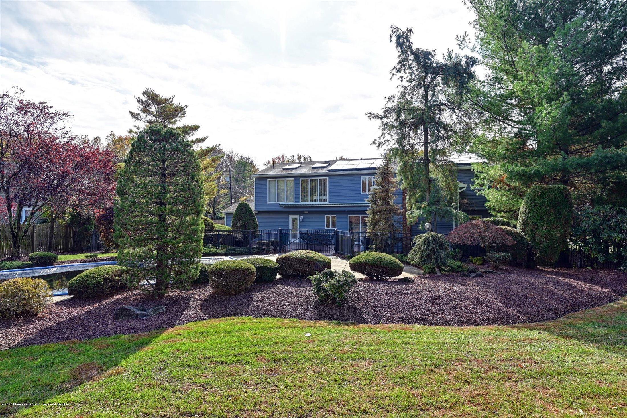 4 Canadian Woods Road Marlboro, NJ 07746 - Photo 31 of 33 a view of a house with backyard and sitting area