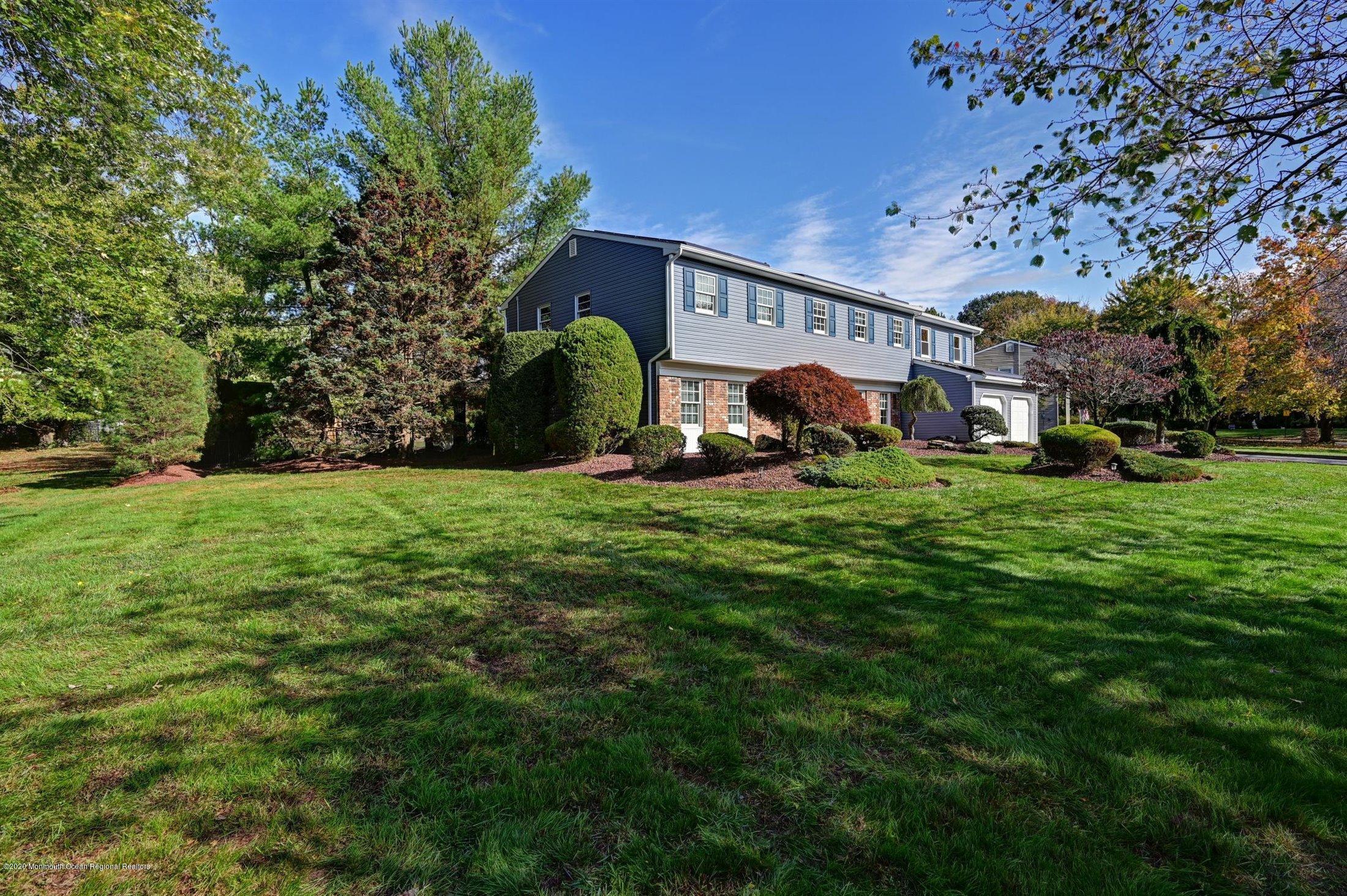 4 Canadian Woods Road Marlboro, NJ 07746 - Photo 33 of 33 a view of a house with a big yard and large trees