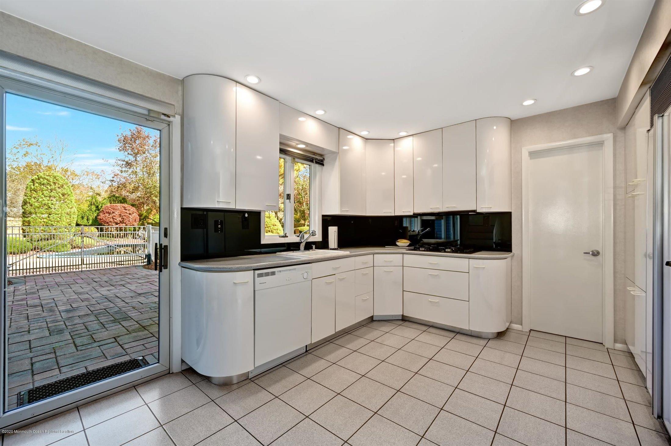 4 Canadian Woods Road Marlboro, NJ 07746 - Photo 10 of 33 a kitchen with a sink and cabinets