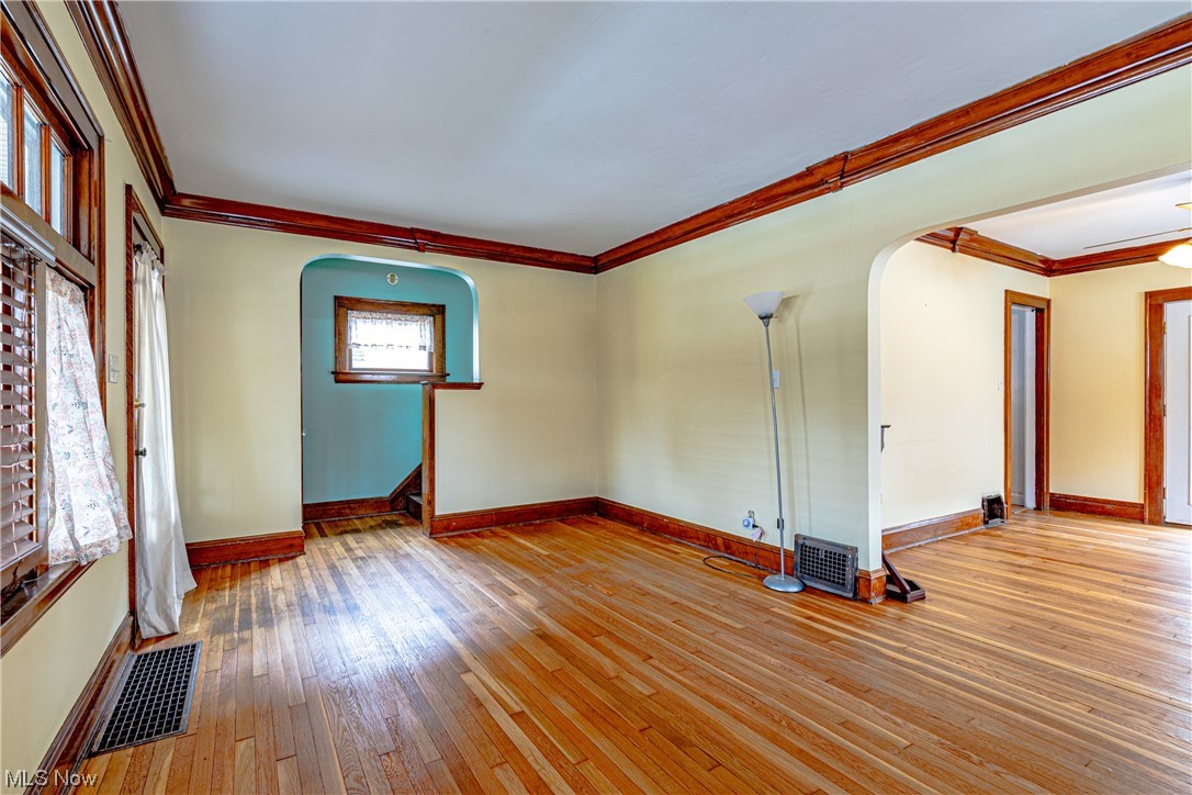 3337 Ralph Avenue Cleveland, OH 44109 - Photo 8 of 30 Empty room featuring light wood-type flooring and crown molding