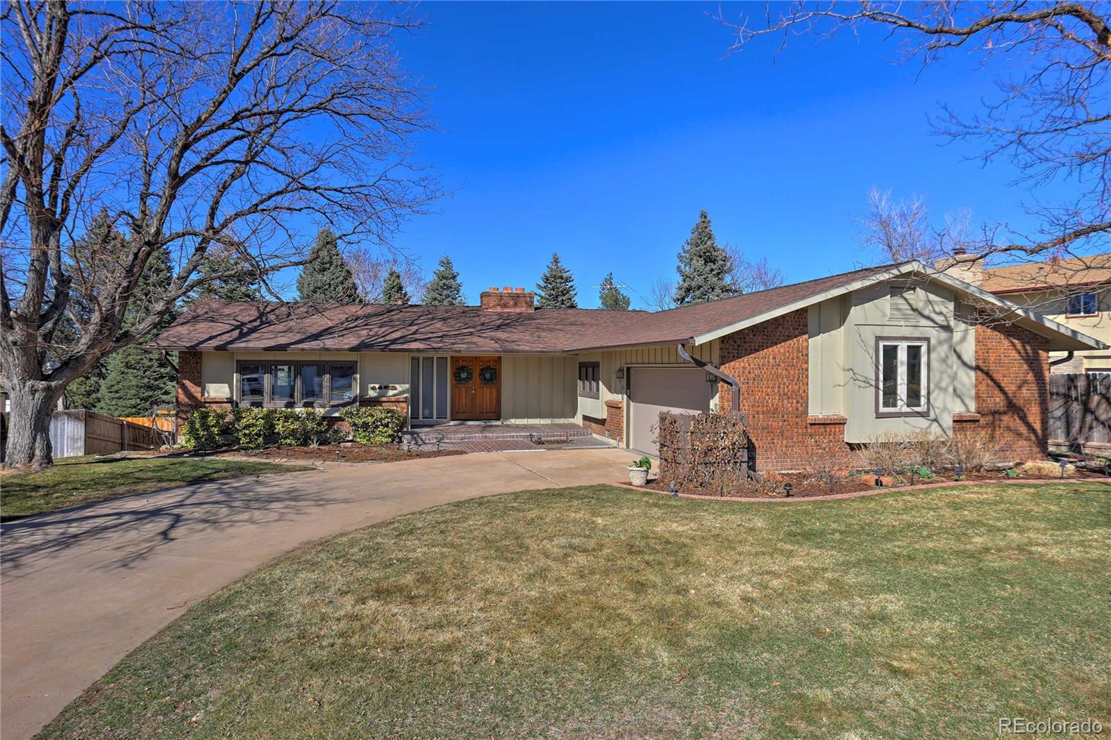 a front view of a house with yard and seating area