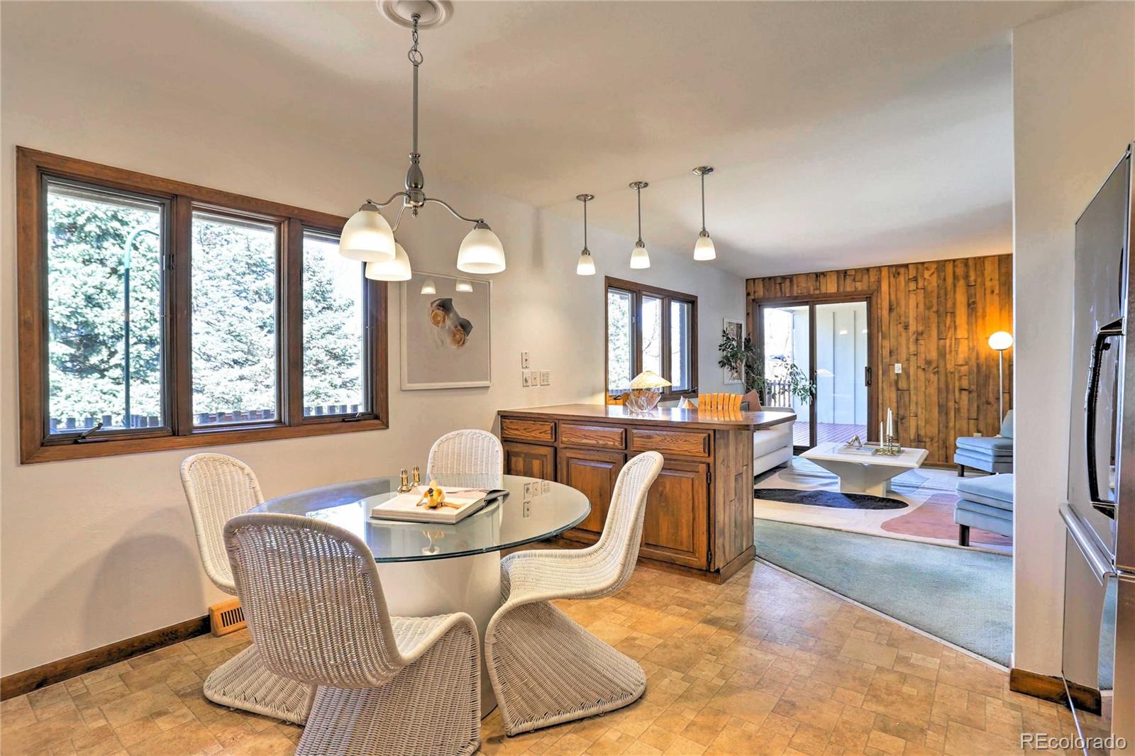 4452 South Xeric Way Denver, CO 80237 - Photo 13 of 40 a dining room with furniture a chandelier and window