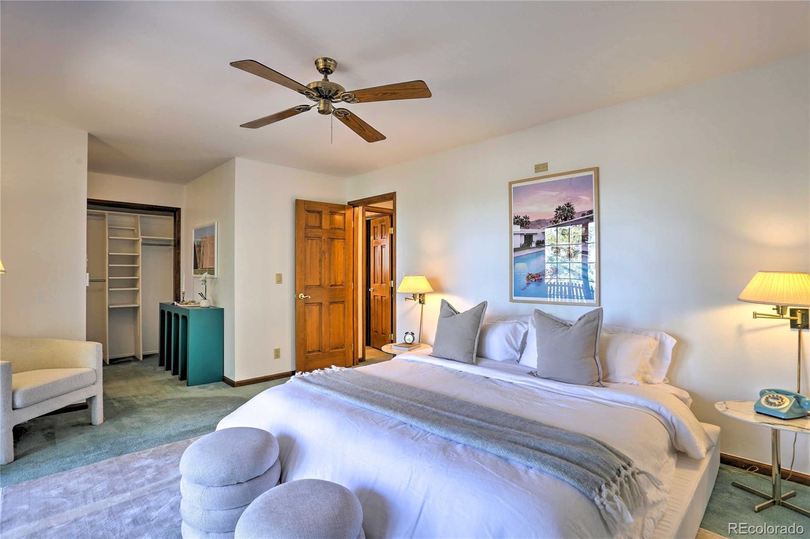 4452 South Xeric Way Denver, CO 80237 - Photo 15 of 40 a bedroom with a bed and a chandelier