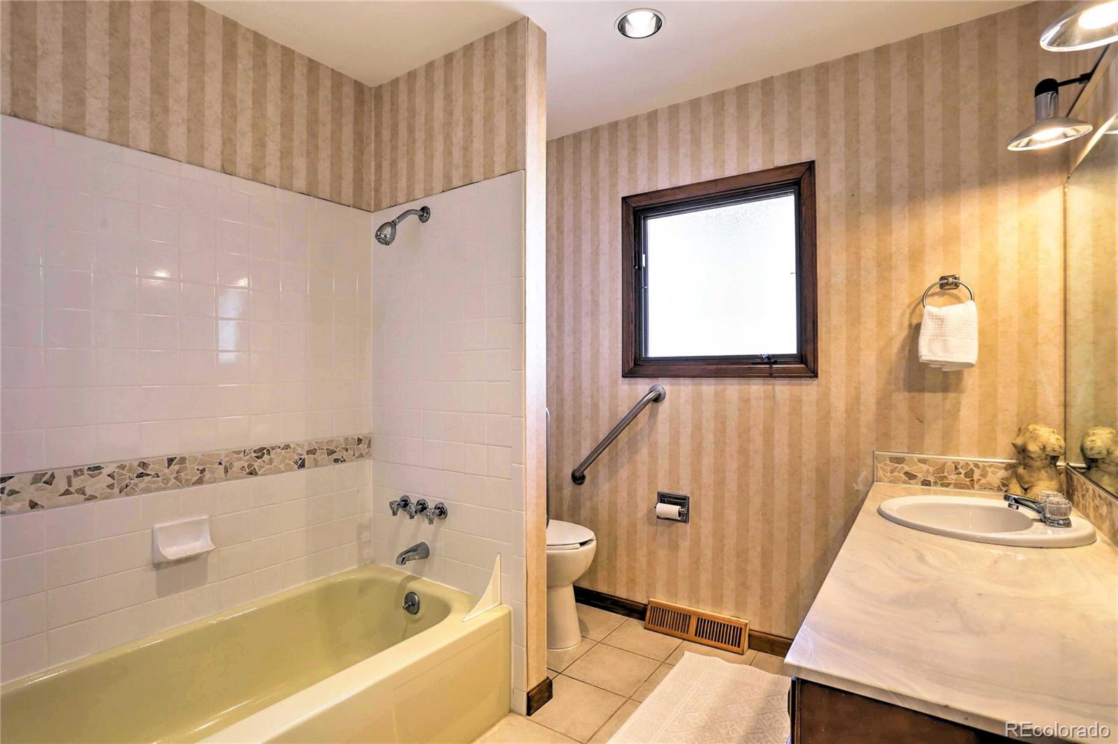 4452 South Xeric Way Denver, CO 80237 - Photo 19 of 40 a bathroom with a bathtub and a sink