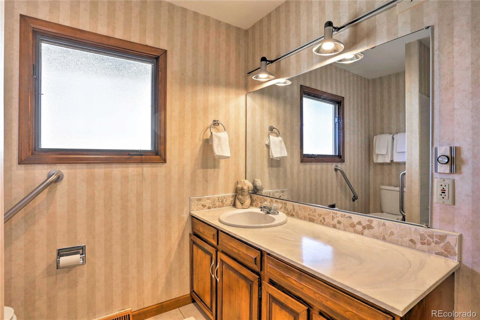 4452 South Xeric Way Denver, CO 80237 - Photo 20 of 40 a bathroom with a sink vanity granite and a mirror