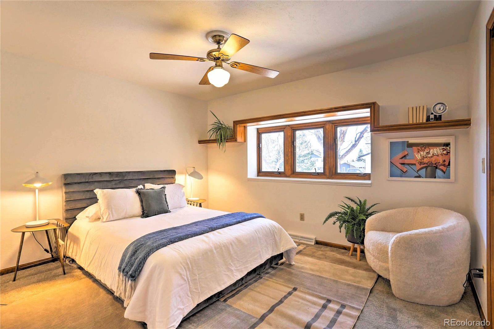 4452 South Xeric Way Denver, CO 80237 - Photo 21 of 40 a bedroom with a large bed and ceiling fan