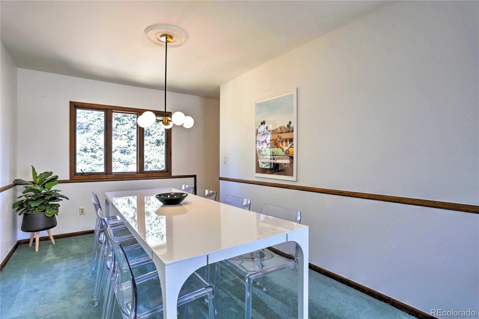 4452 South Xeric Way Denver, CO 80237 - Photo 8 of 40 a view of a dining room with furniture window and wooden floor