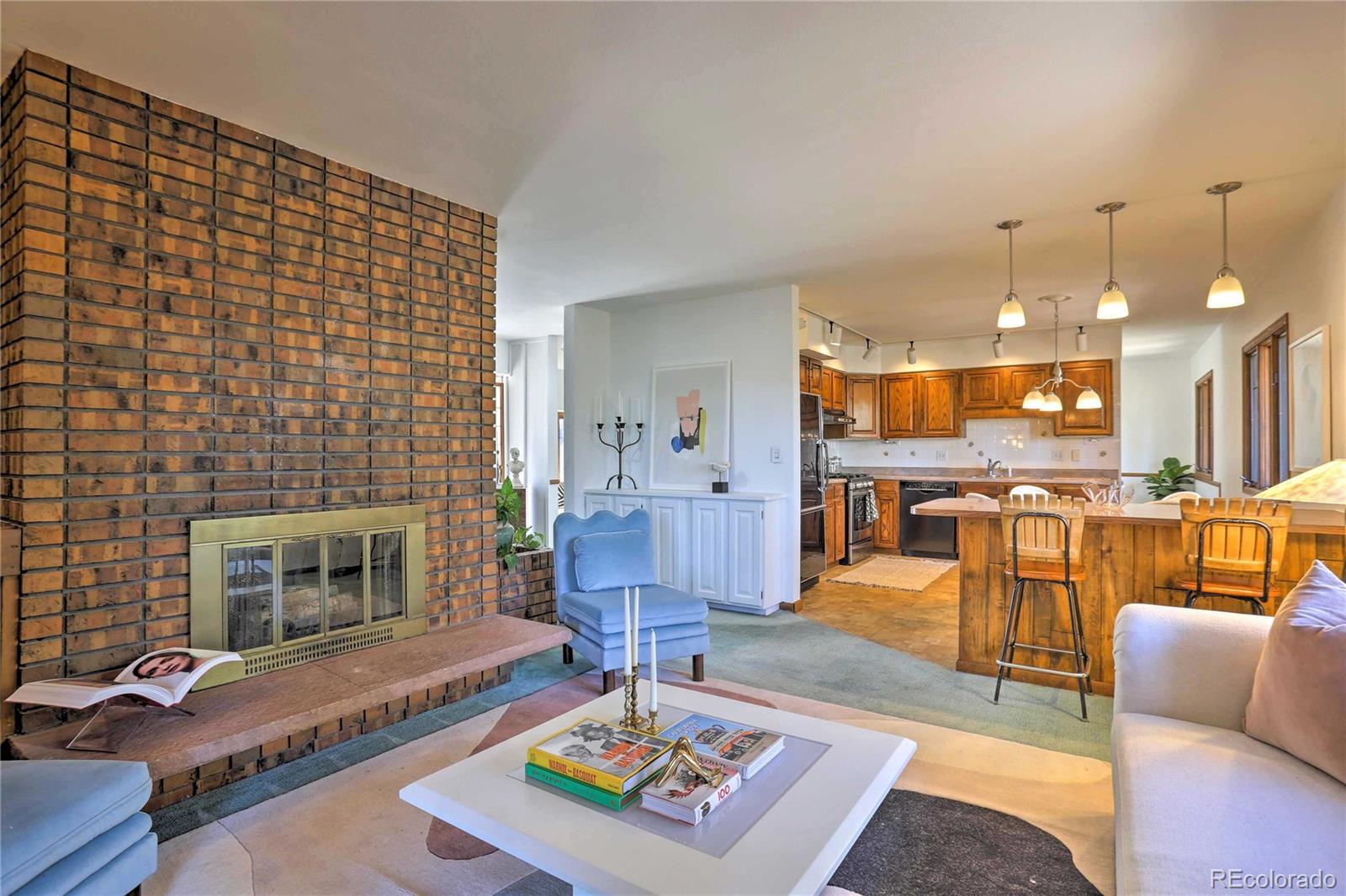 4452 South Xeric Way Denver, CO 80237 - Photo 10 of 40 a living room with furniture and a fireplace