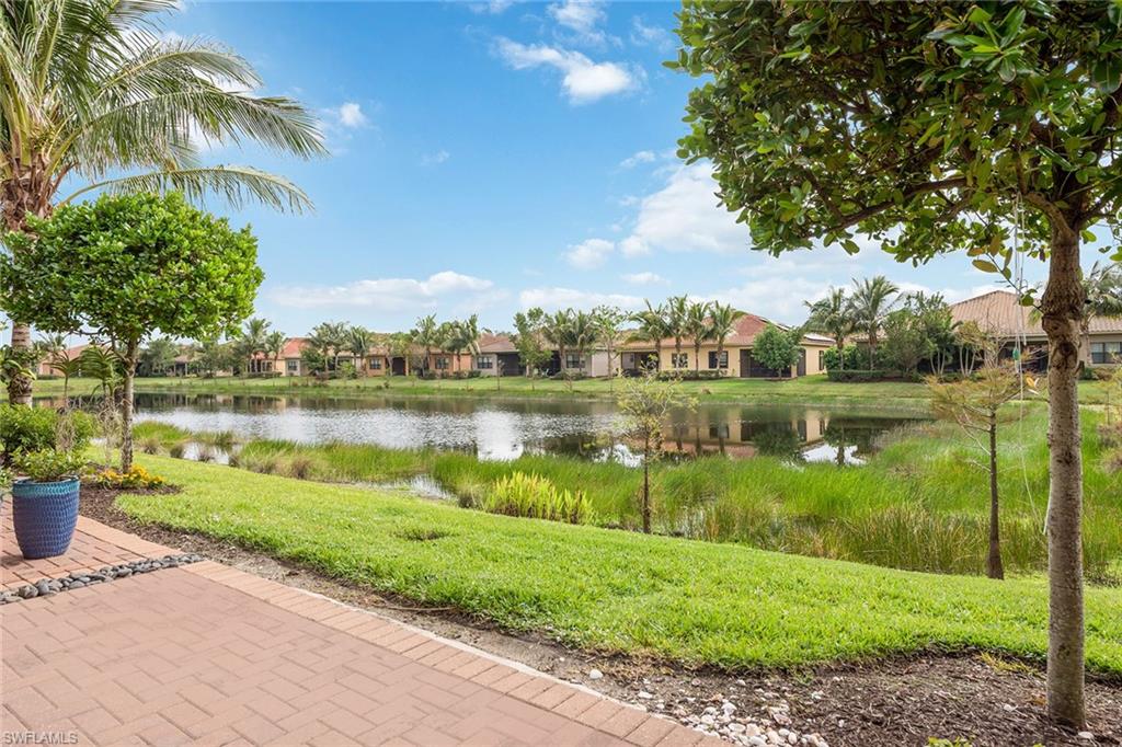 13338 Coronado Drive Naples, FL 34109 - Photo 13 of 22 a view of a lake with a house in the background