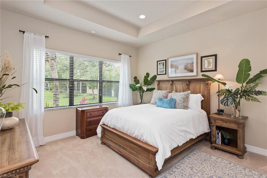 13338 Coronado Drive Naples, FL 34109 - Photo 6 of 22 a bedroom with a large bed and a window