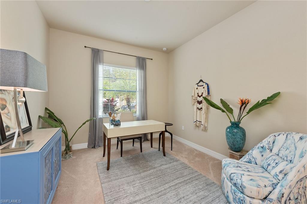13338 Coronado Drive Naples, FL 34109 - Photo 8 of 22 a living room with furniture a potted plant and a table