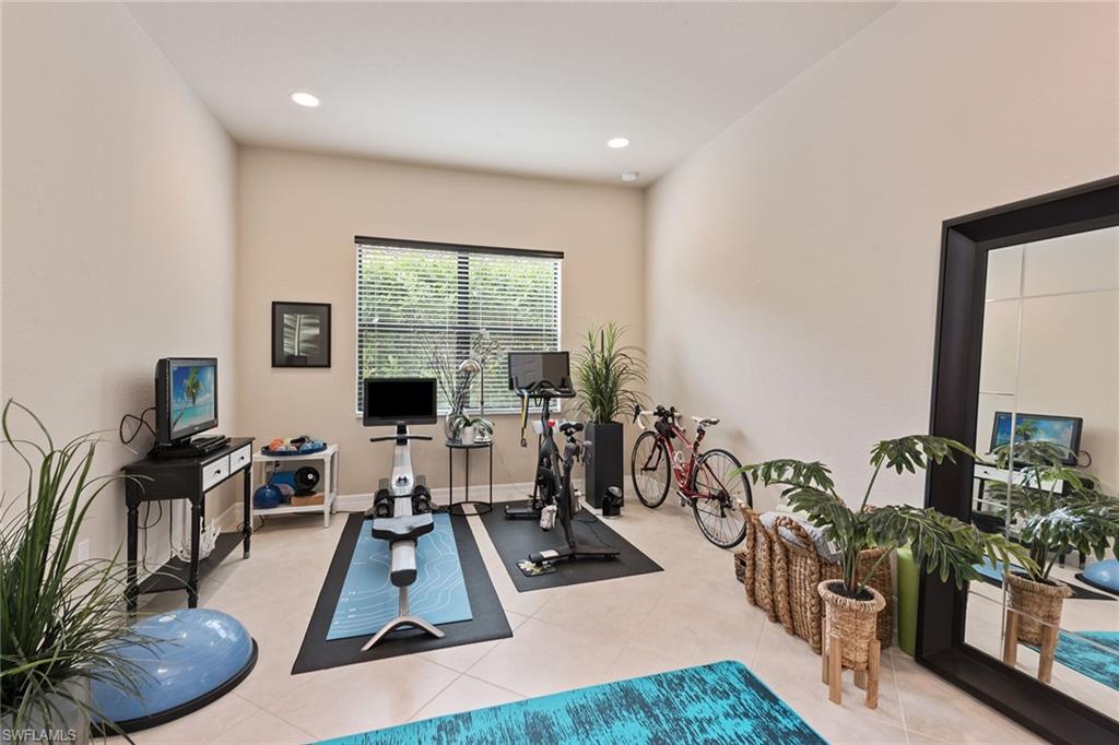 13338 Coronado Drive Naples, FL 34109 - Photo 10 of 22 a room with furniture and a flat screen tv