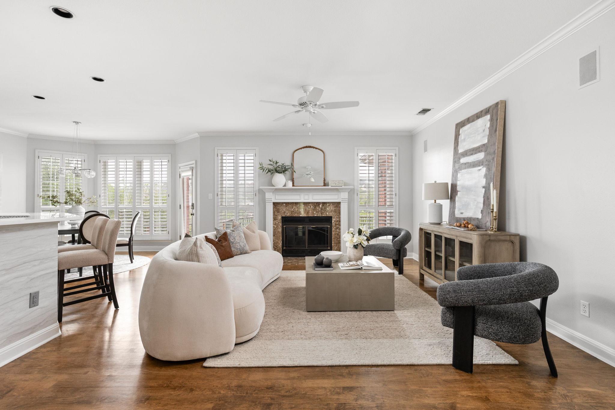 2807 Round Table Road Austin, TX 78746 - Photo 5 of 40 Open-concept living area with wood-finish flooring, recessed lighting, and crown molding