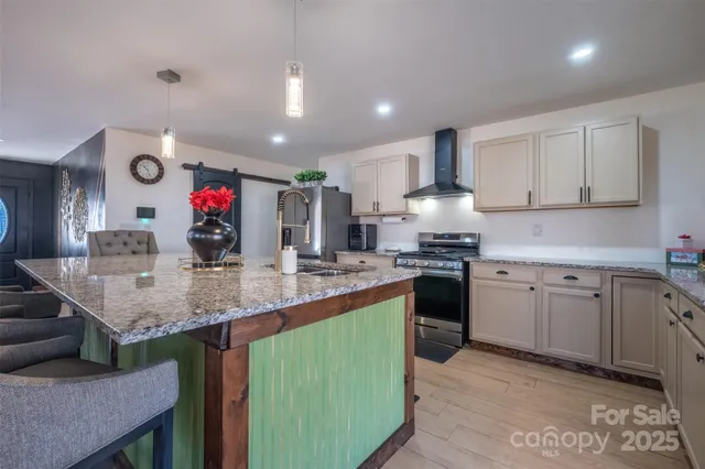 a kitchen with granite countertop a sink cabinets and wooden floor