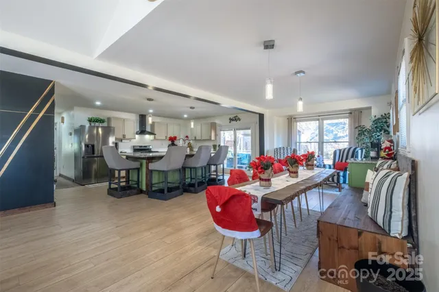 a living room with furniture a wooden floor and a chandelier