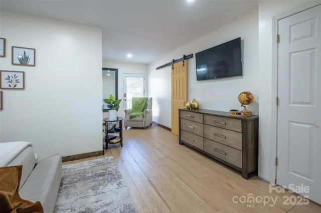 a room with furniture and flat screen tv