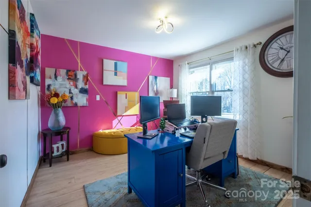 a view of a livingroom with workspace and a couch