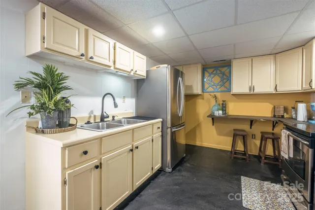 a kitchen with a sink cabinets and appliances