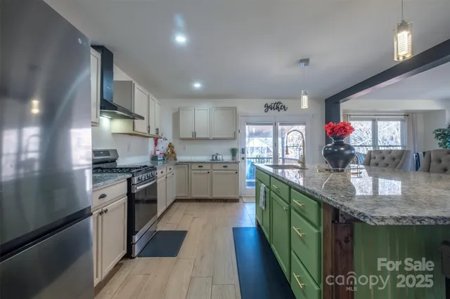 a kitchen with granite countertop lots of counter top space and stainless steel appliances