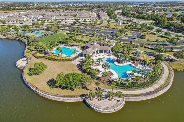 an aerial view of a house with swimming pool and ocean view