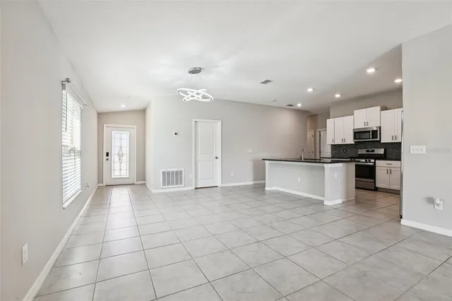 a view of kitchen with stainless steel appliances a refrigerator and a stove top oven