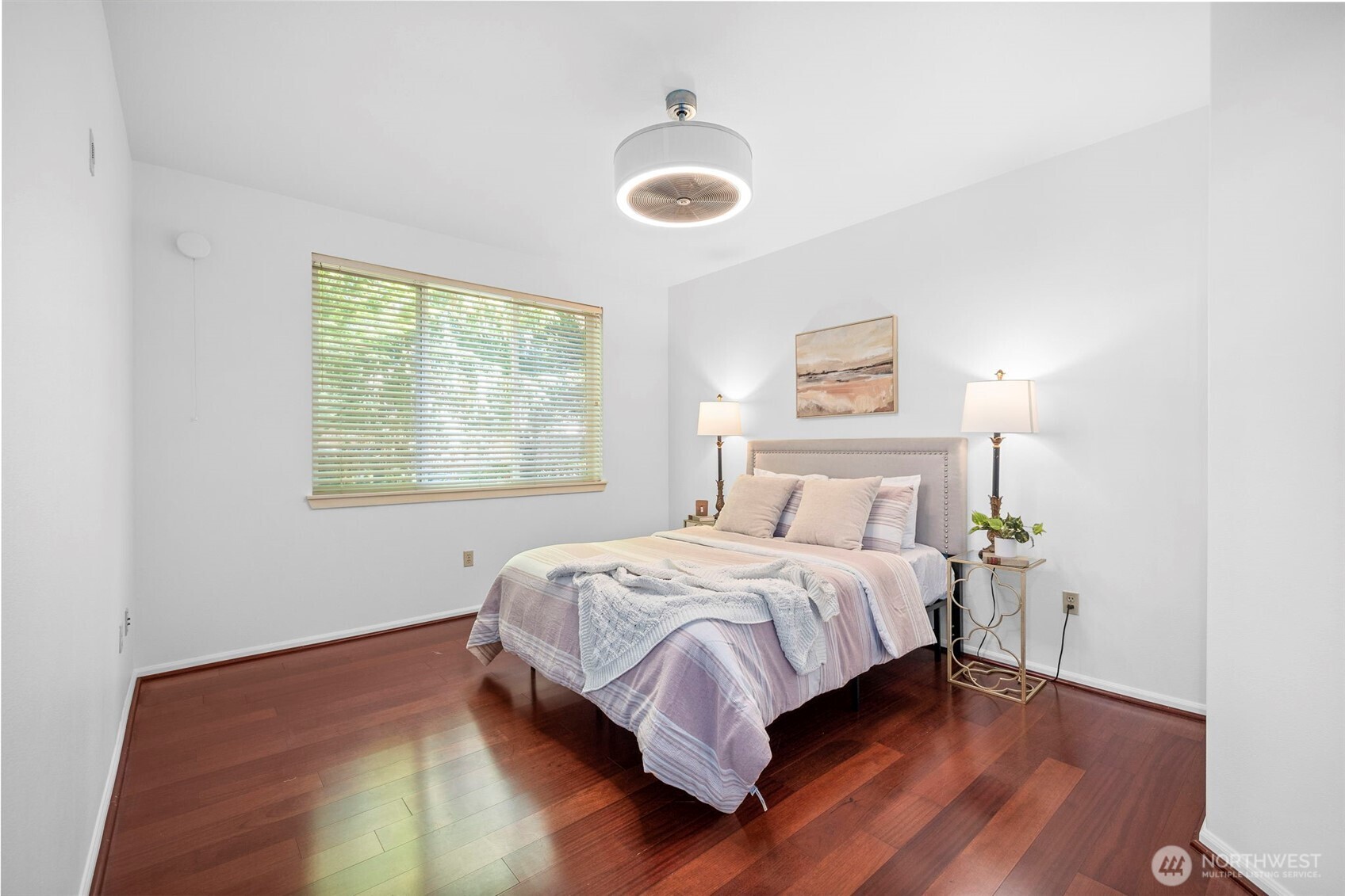 4310 Northeast 5th Court, Unit 101 Renton, WA 98059 - Photo 5 of 16 a bed sitting in a bedroom next to a window