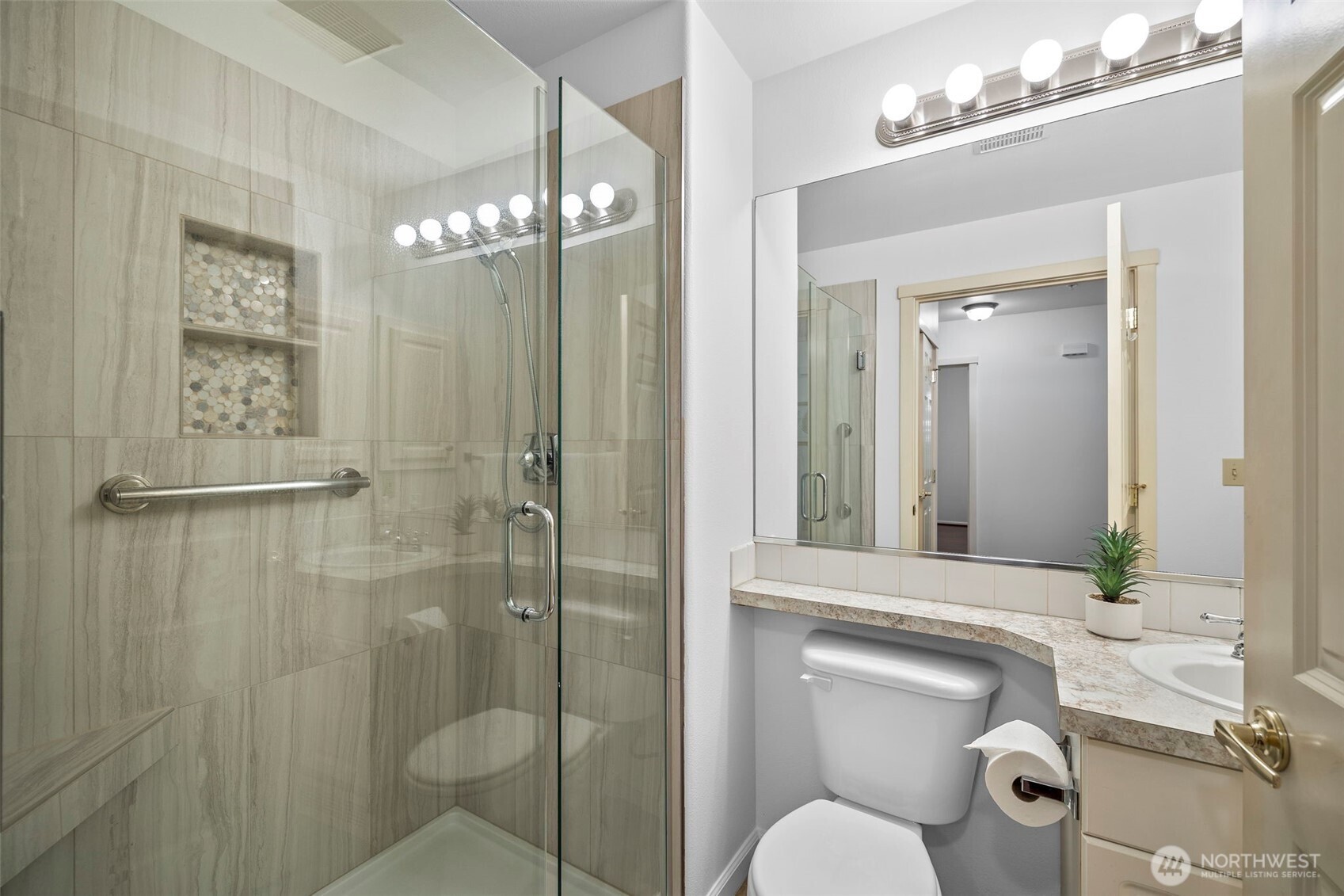 4310 Northeast 5th Court, Unit 101 Renton, WA 98059 - Photo 10 of 16 a bathroom with a toilet a sink and shower