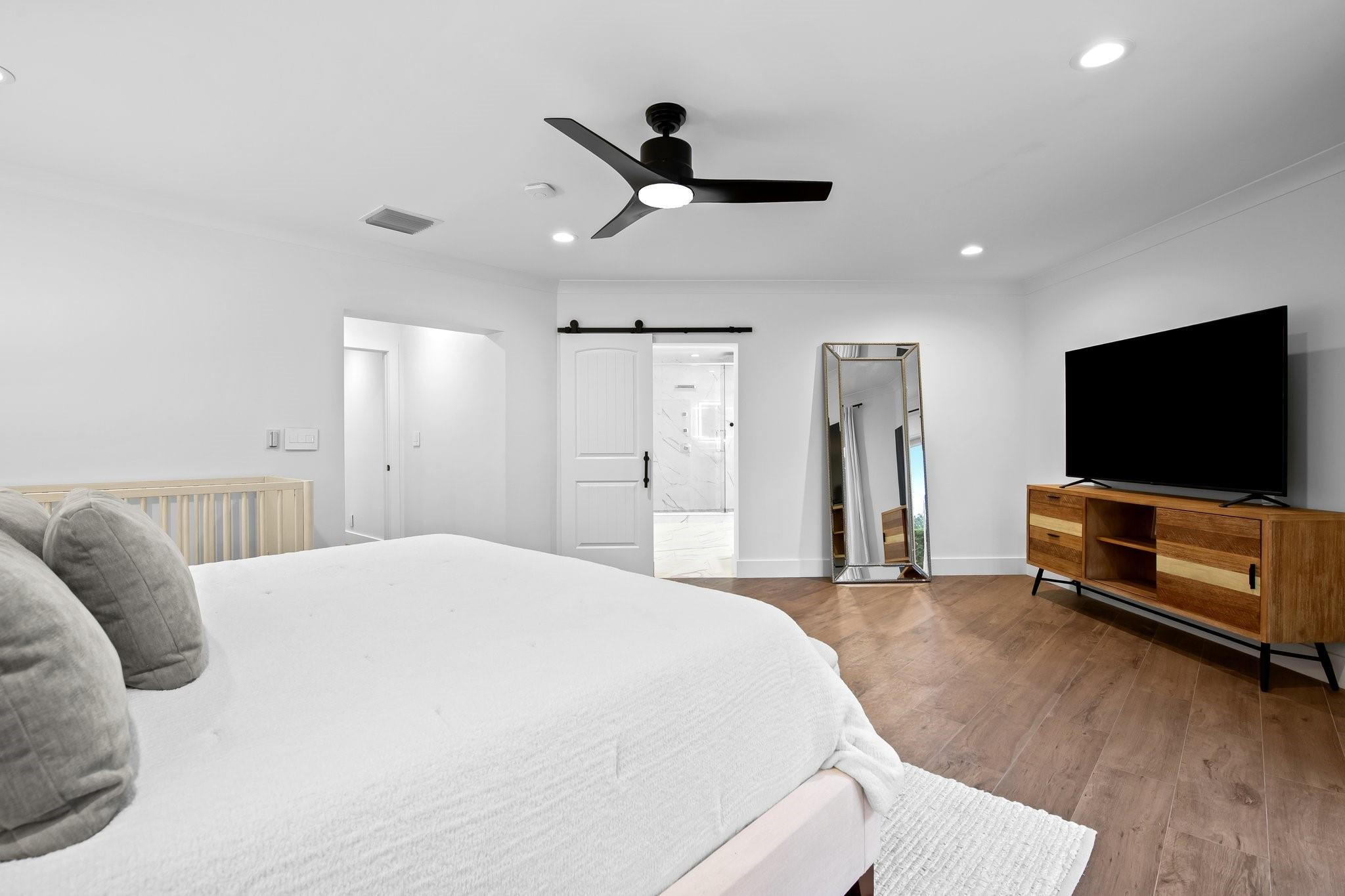 5751 Plantation Road Plantation, FL 33317 - Photo 16 of 32 a bedroom with a bed and a flat screen tv