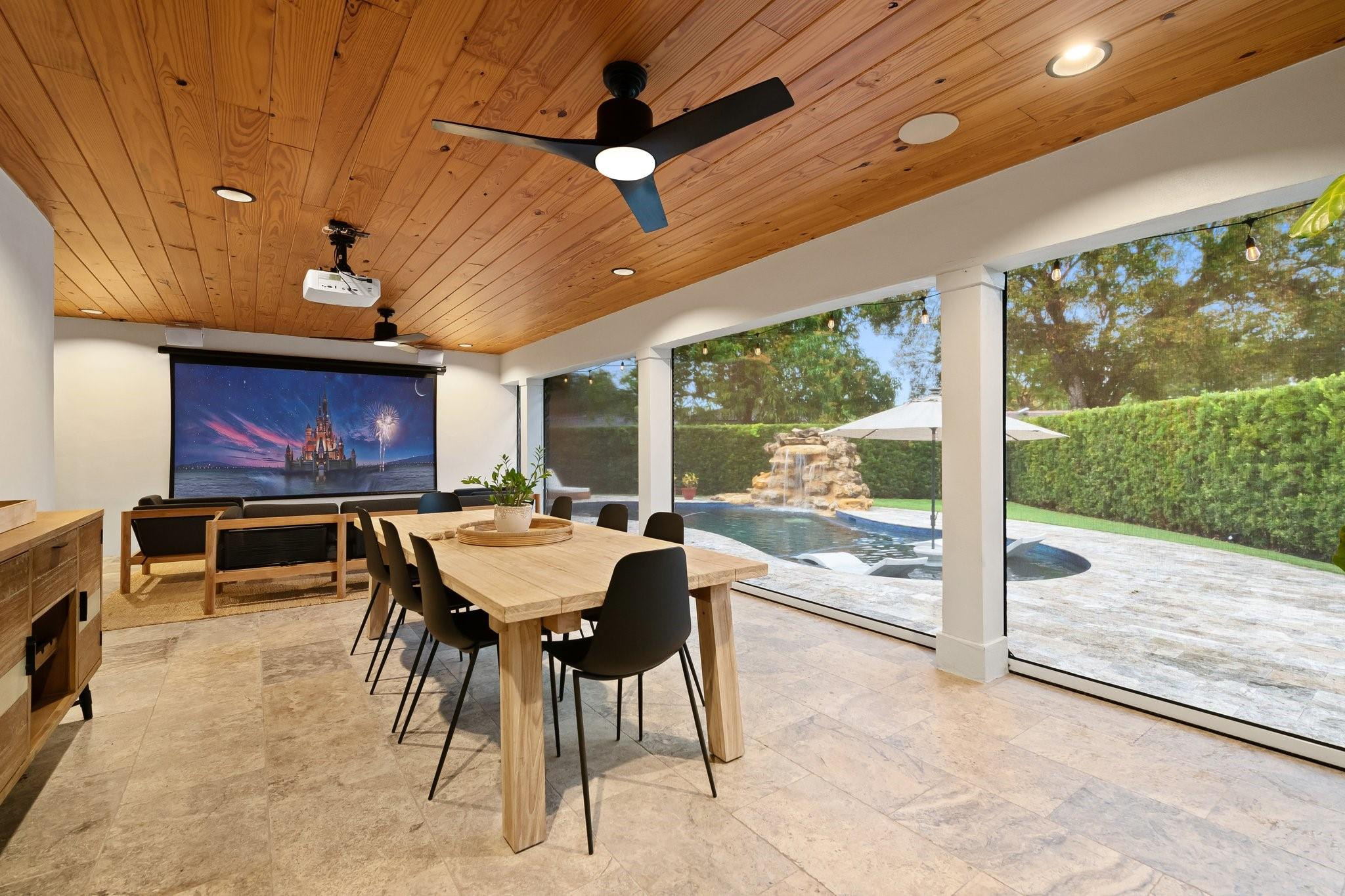 5751 Plantation Road Plantation, FL 33317 - Photo 27 of 32 a view of a dining room with furniture large windows and a chandelier