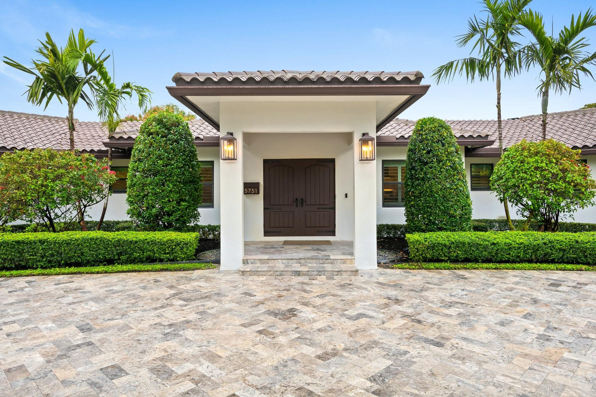 5751 Plantation Road Plantation, FL 33317 - Photo 4 of 32 a front view of a house with a garden