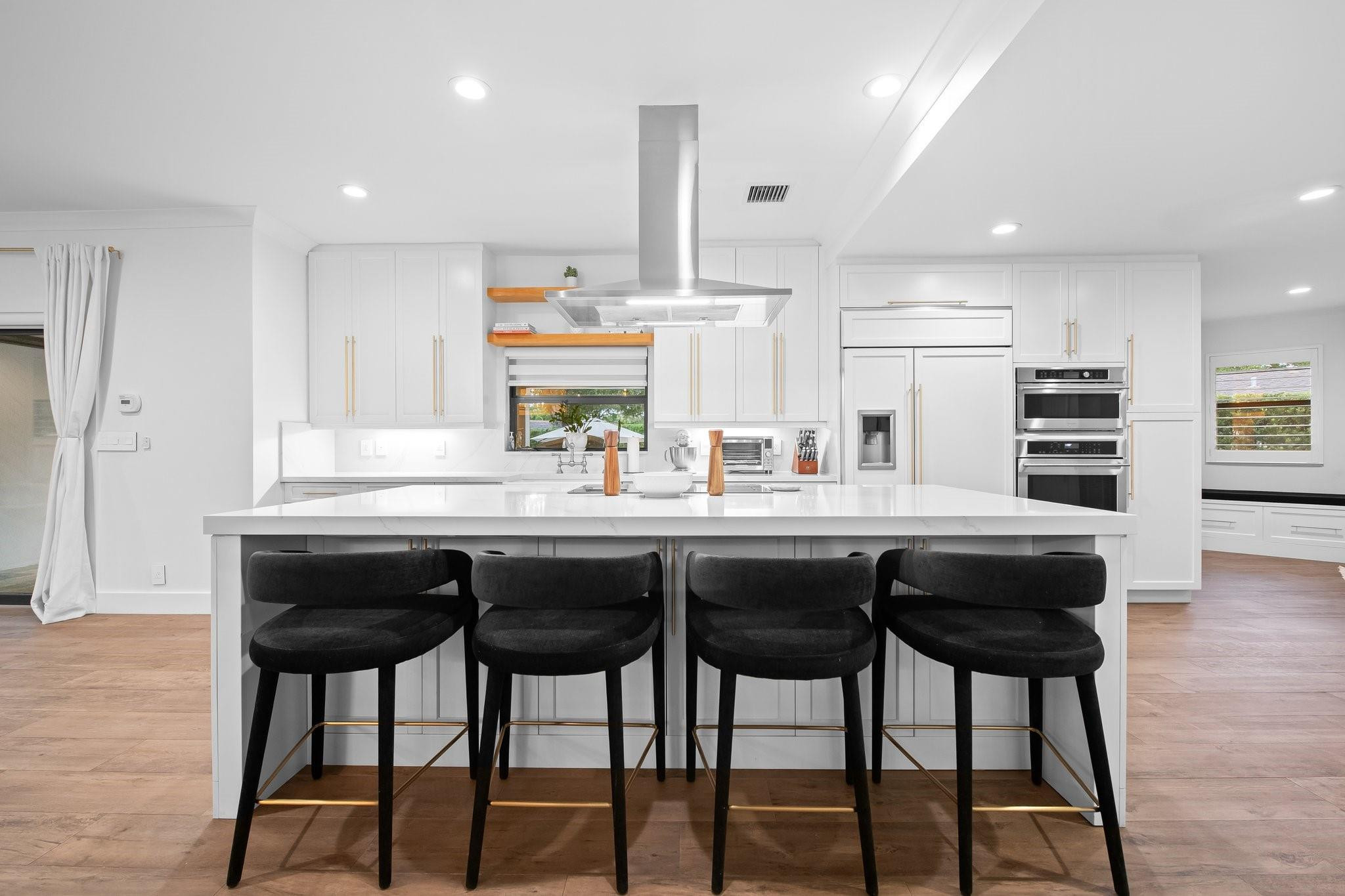 5751 Plantation Road Plantation, FL 33317 - Photo 10 of 32 a kitchen with stainless steel appliances granite countertop a table chairs sink and cabinets
