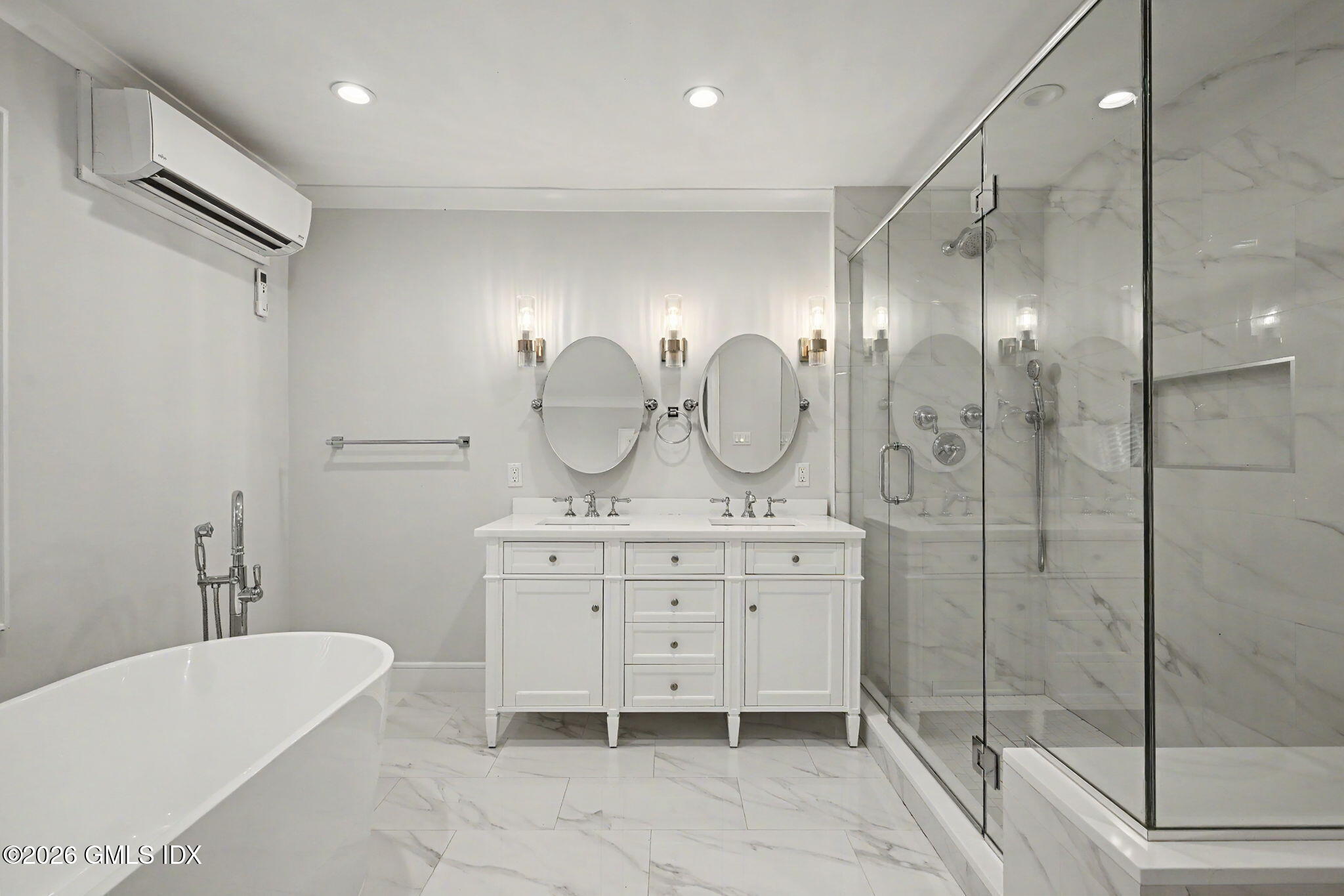 124 Shore Road Old Greenwich, CT 06870 - Photo 16 of 28 a spacious bathroom with a double vanity sink mirror and bathtub