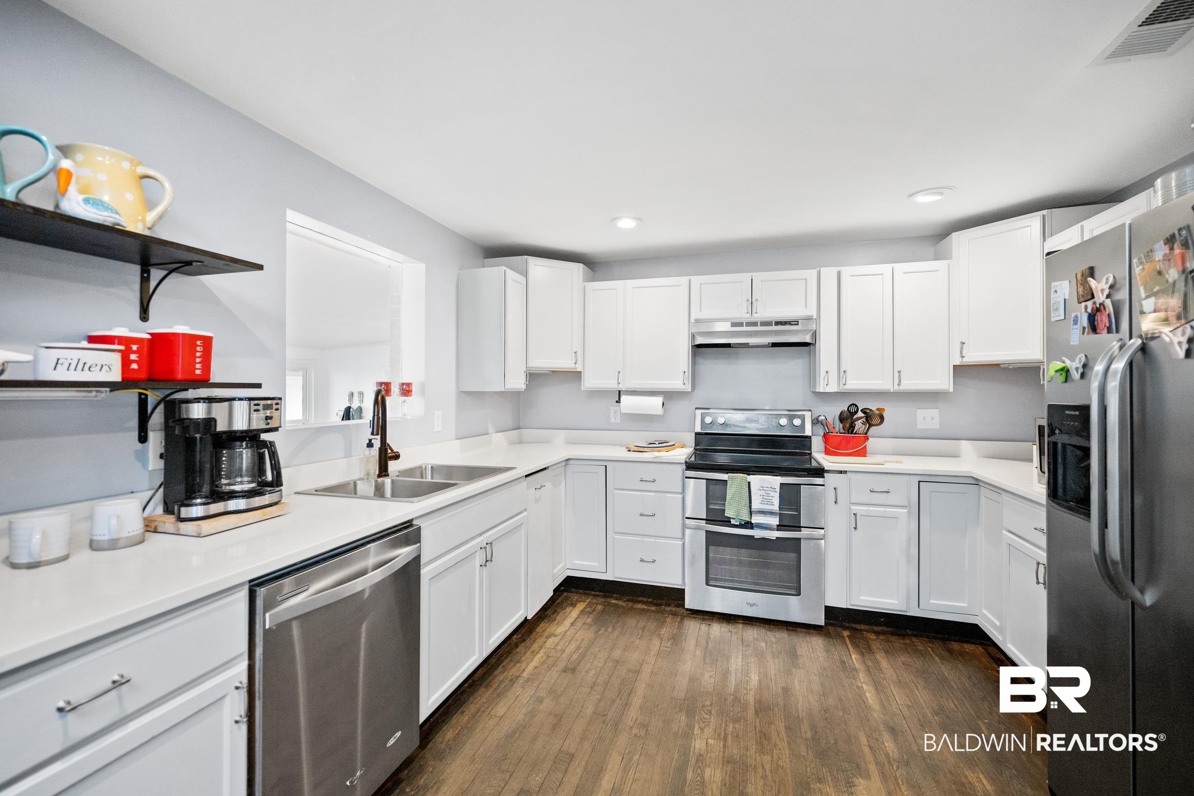 401 West Myrtle Avenue Foley, AL 36535 - Photo 14 of 39 Kitchen featuring appliances with stainless steel finishes, white cabinetry, open shelves, under cabinet range hood, and dark wood-type flooring