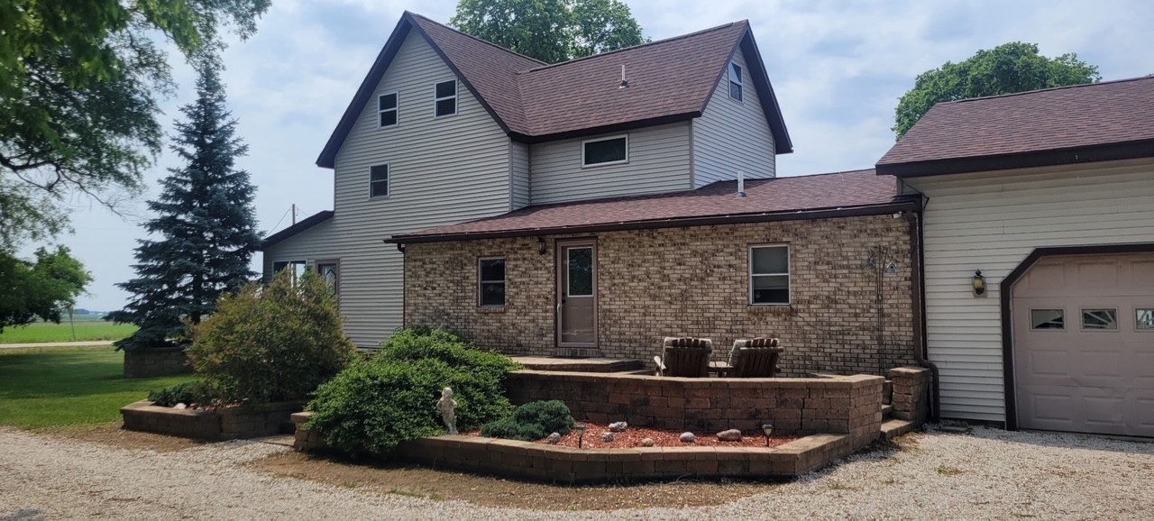 382 Keigwin Road Walnut, IL 61376 - Photo 1 of 49 a front view of a house with a garden