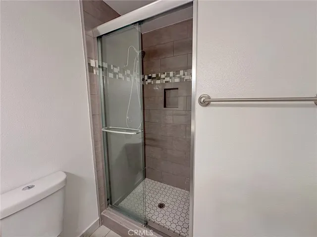 a bathroom with a glass shower door