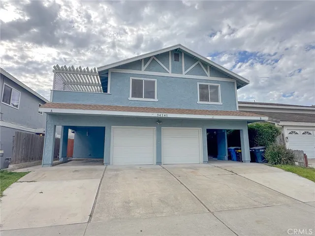 a view of a house with a yard and garage