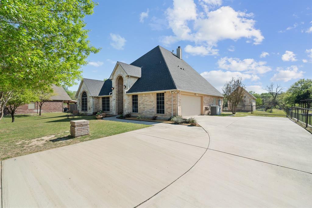 112 Waterfall Court Azle, TX 76020 - Photo 3 of 40 You could drive up to this every day!! See your little workshop and the gate to an amazing retreat out there? House with five bedrooms, an office that doubles as a sunroom.