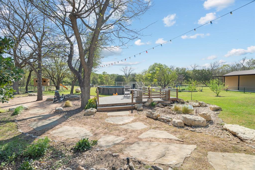 112 Waterfall Court Azle, TX 76020 - Photo 31 of 40 Secondary deck near the koi pond, firepit, play area and steps from the pool...