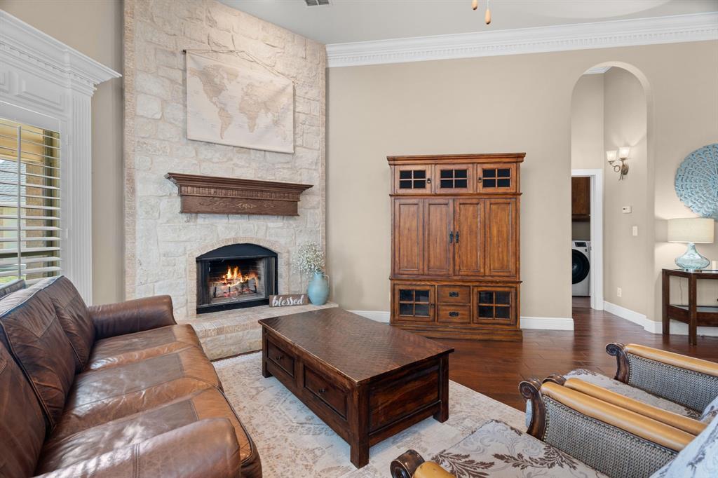 112 Waterfall Court Azle, TX 76020 - Photo 7 of 40 Gorgeous stone wood burning fireplace centers the family room.