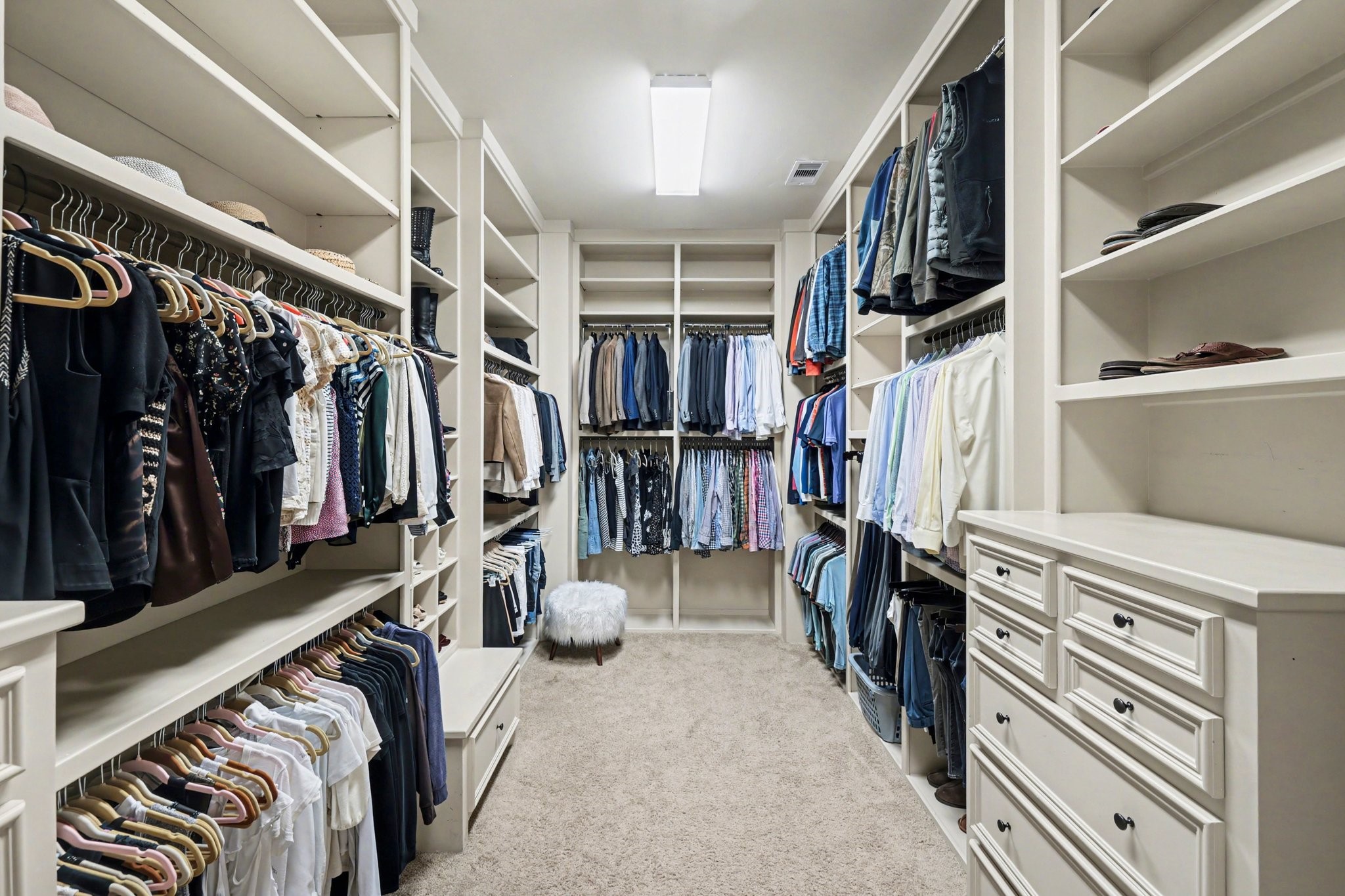 3 Player Ridge Court The Woodlands, TX 77382 - Photo 19 of 50 Expansive primary closet featuring extensive built-ins, drawers, and plenty of hanging space.
