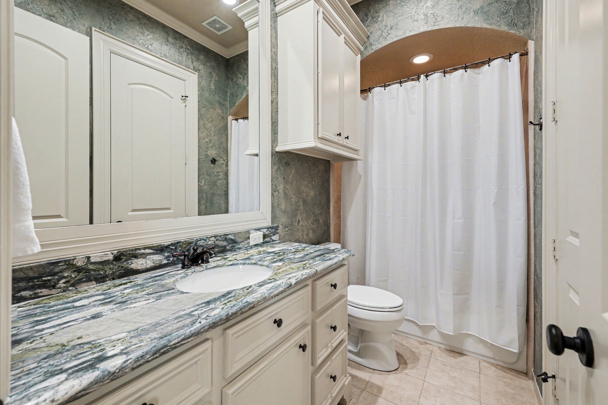 3 Player Ridge Court The Woodlands, TX 77382 - Photo 30 of 50 Secondary bathroom with a combination tub and shower, stunning countertops, and lots of storage.
